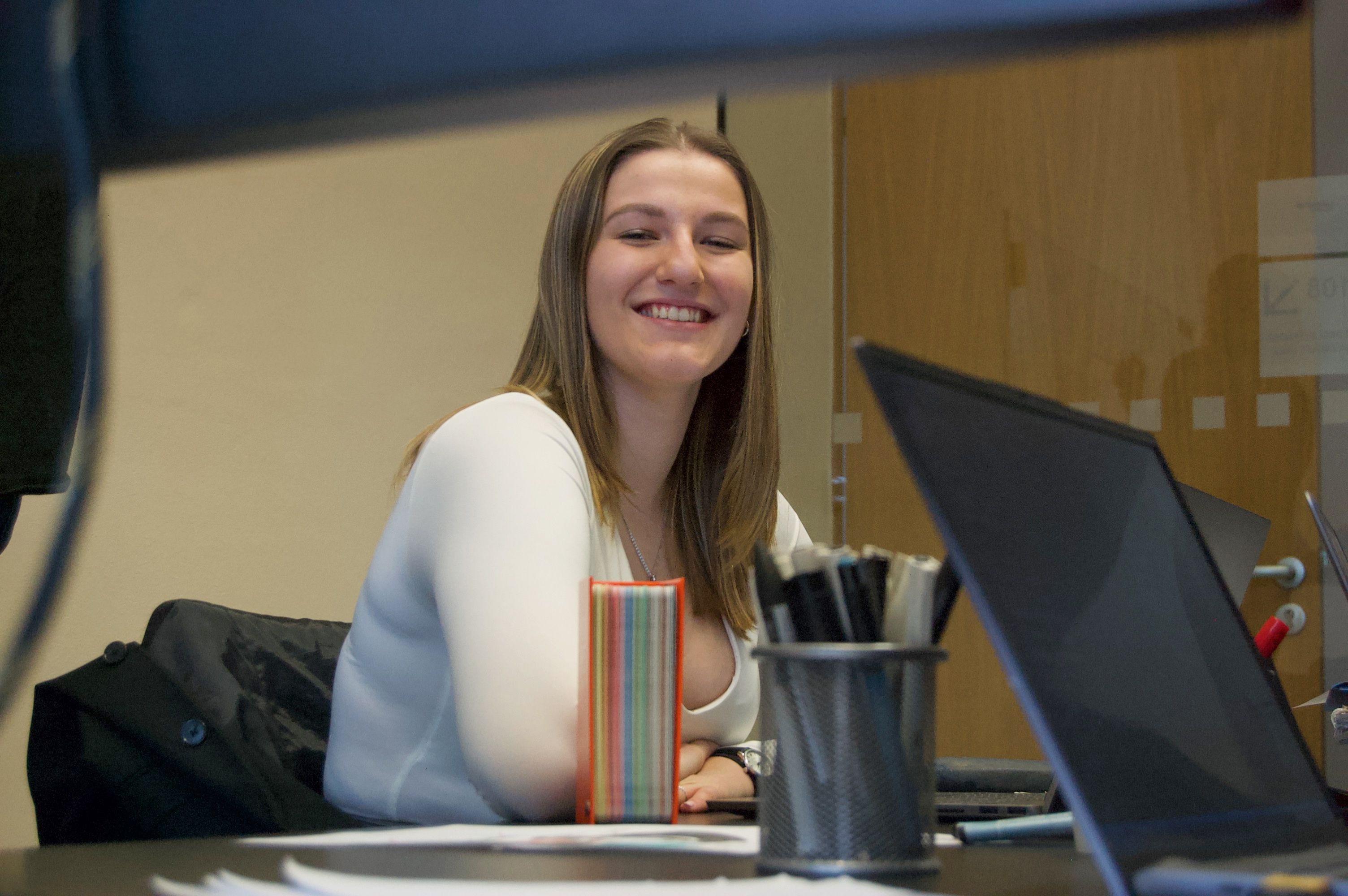 A smiling, working young woman.