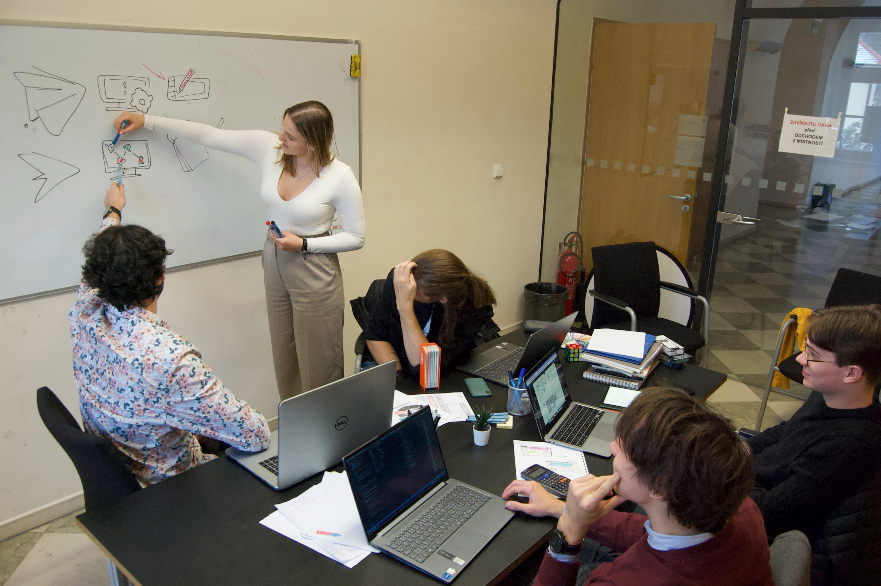 A team working together and planning on a whiteboard.